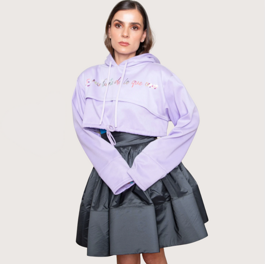 Woman wearing a light purple hoodie with text and a gray skirt on a white background, with a 'Hot Sale' tag in the corner.
